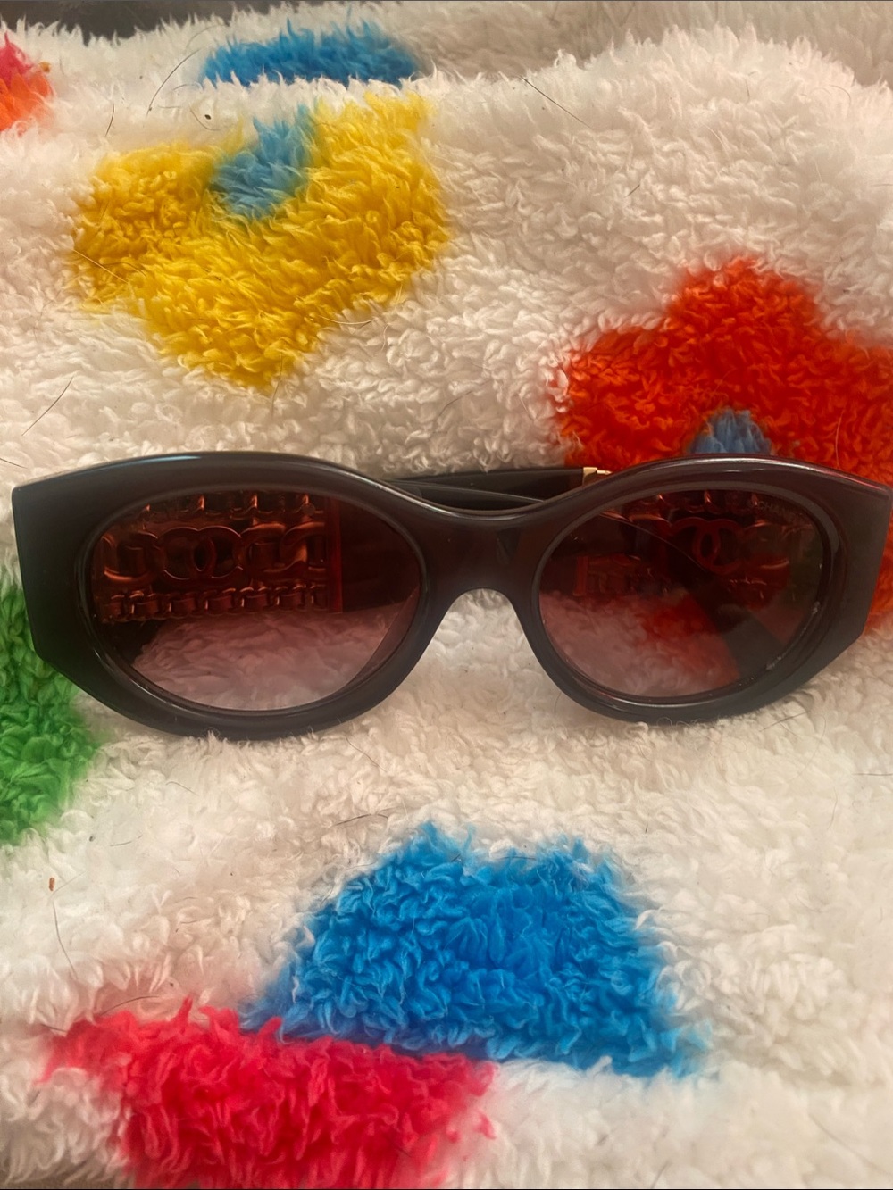 CHANEL Black Oval Sunglasses with Dark Red Lenses